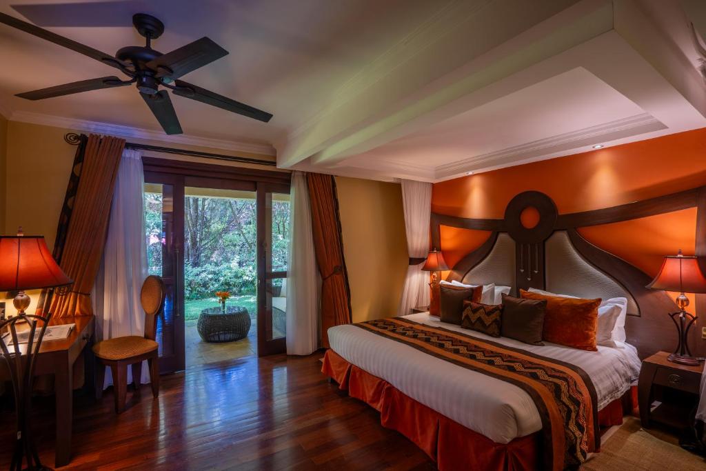 a bedroom with a bed and a ceiling fan at Enashipai Resort & Spa in Naivasha