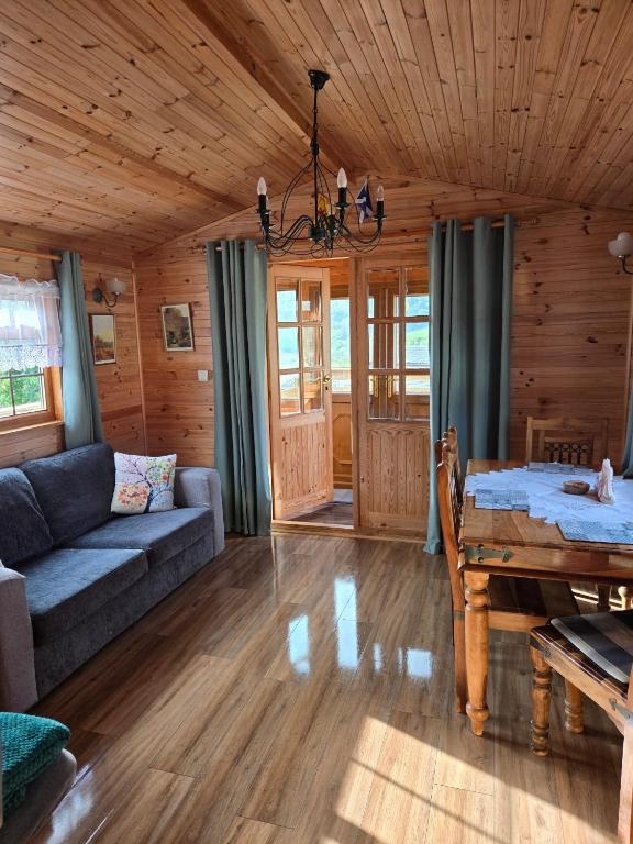 a living room with a couch and a table at Unique Caravan with Outdoor Space Lodge in Ballantrae