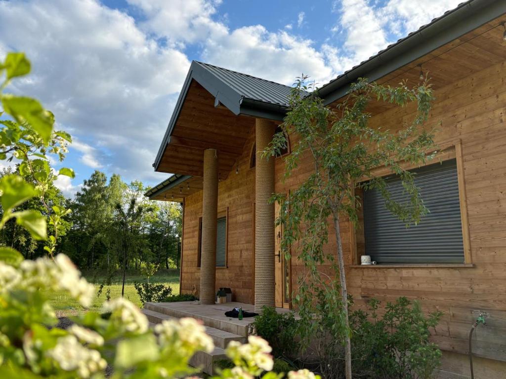 a house with a solarium on the side of it at Kryształowy Domek 