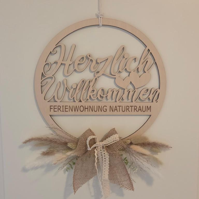 a christmas ornament with a bow on a wall at FeWo Naturtraum in Kastellaun