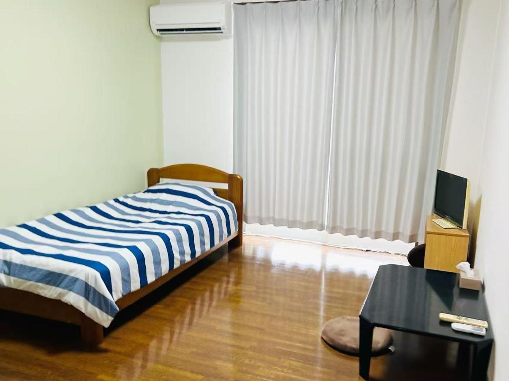 Ένα ή περισσότερα κρεβάτια σε δωμάτιο στο アルピエj107号室無料Wi-Fiあり熊本城徒歩5分