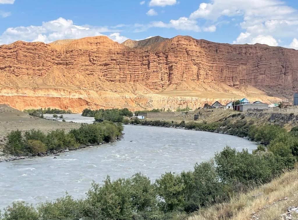 een rivier met een berg op de achtergrond bij Eco house in Naryn