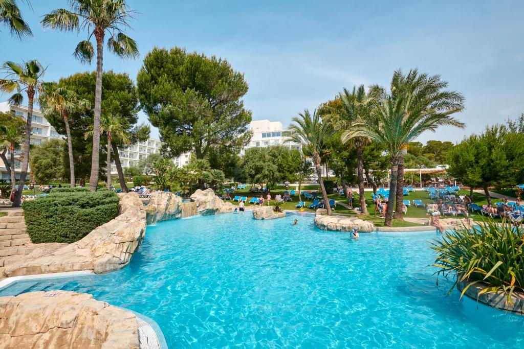 a pool in a resort with people in it at Grupotel Gran Vista & Spa in Can Picafort