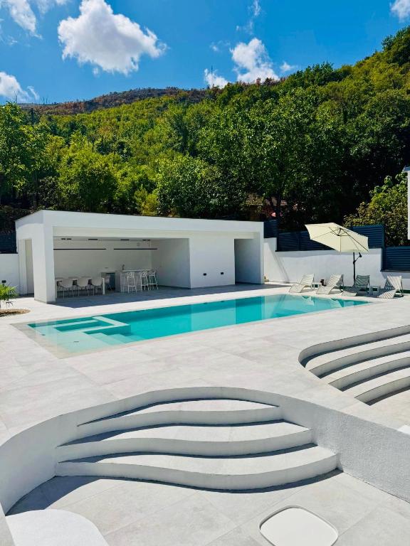 a house with a swimming pool and some stairs at Villa Naléj in Mostar