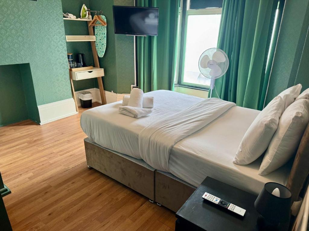 a bedroom with a bed with a window and a television at Number 19 Brighton in Brighton & Hove