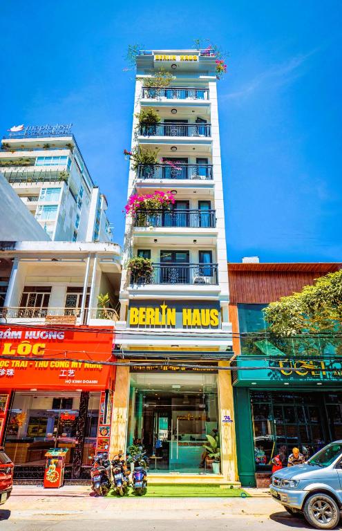 a tall white building with a sign that reads breath halls at Berlin Haus Nha Trang Hotel in Nha Trang