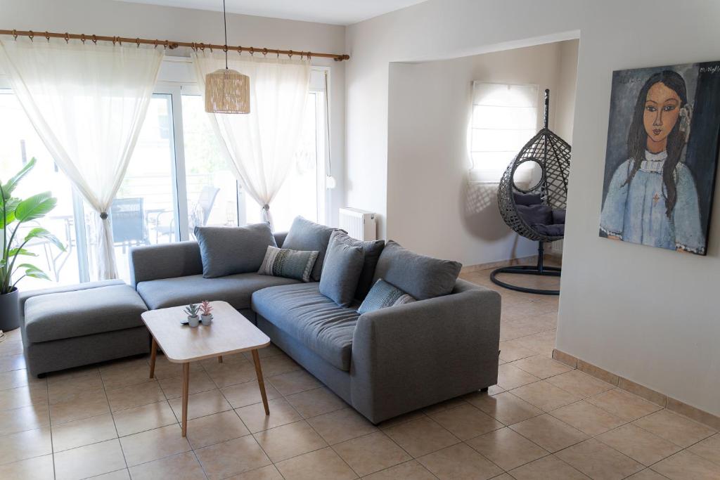 a living room with a couch and a table at Lovemade central apartment in Kos Town