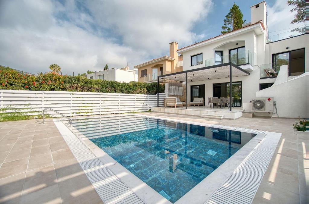 a swimming pool in front of a house at River Pearl Villa in Tala
