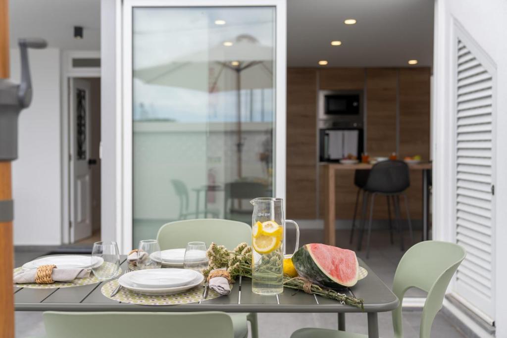 a dining table with a plate of food on it at Casa Branca 36 by An Island Apart in Funchal