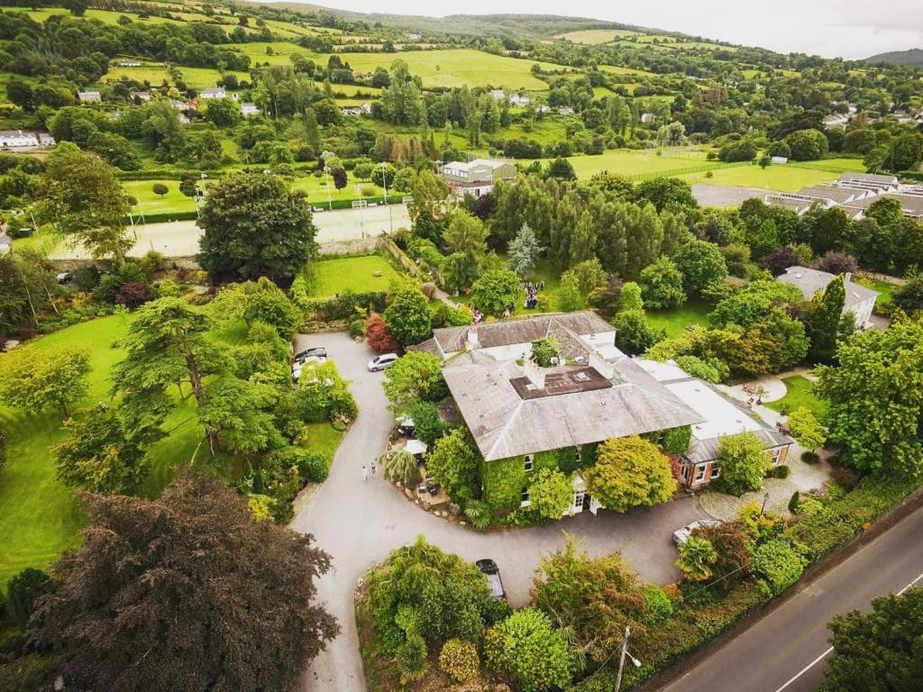 an aerial view of a house with a river at Raheen House Hotel in Clonmel