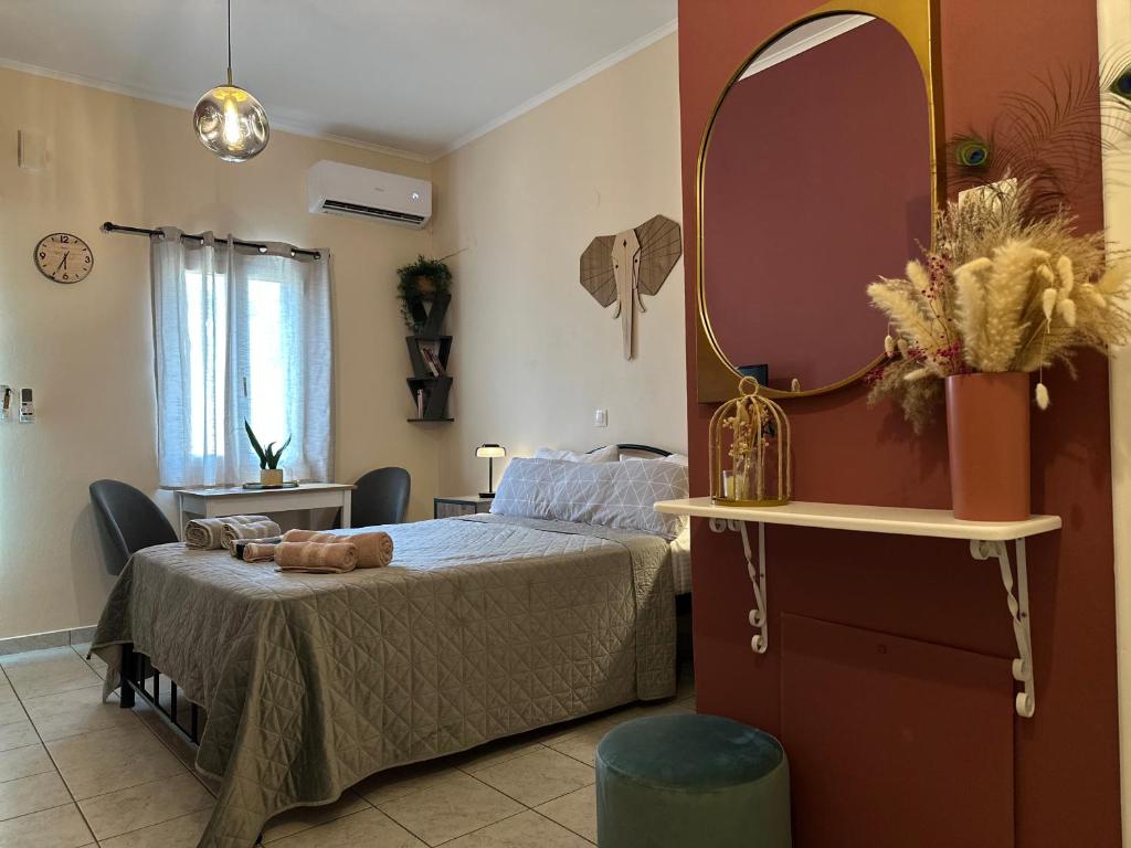 a bedroom with a bed and a large mirror at Jo's Studios in Mirina
