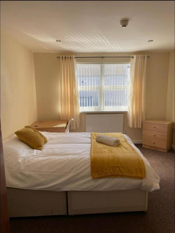 a bedroom with a large white bed with a window at 34 - Room 3 - Uplands in Swansea