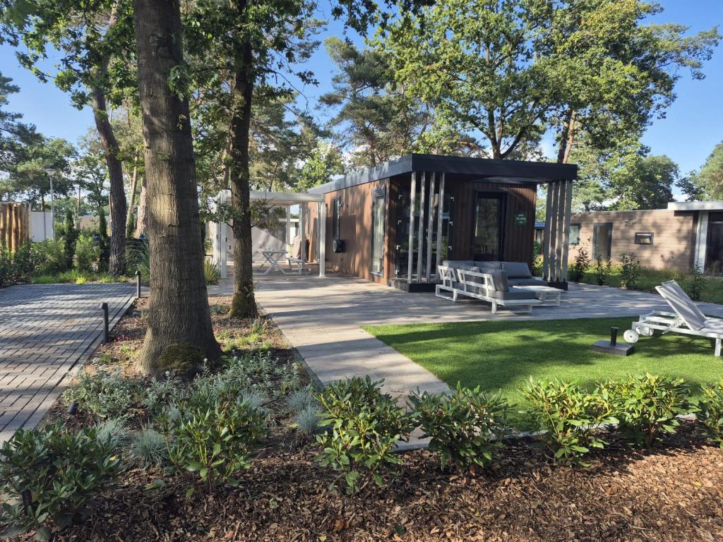 a modern house with a black roof at Casa Sallandia met Outdoor Wellness! in Haarle