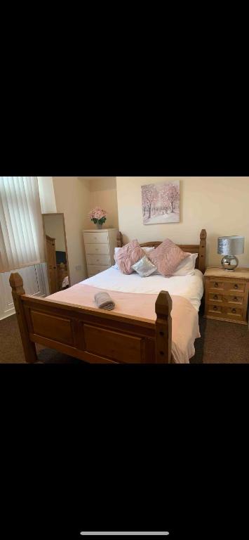 a bedroom with a large bed with white sheets at 34 - Room 4 - Uplands in Swansea