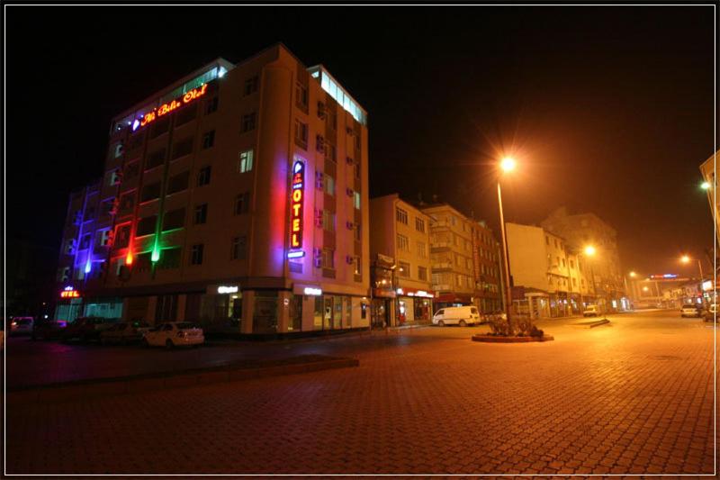 a building with a neon sign on it at night at Ali Bilir Otel in Beysehir