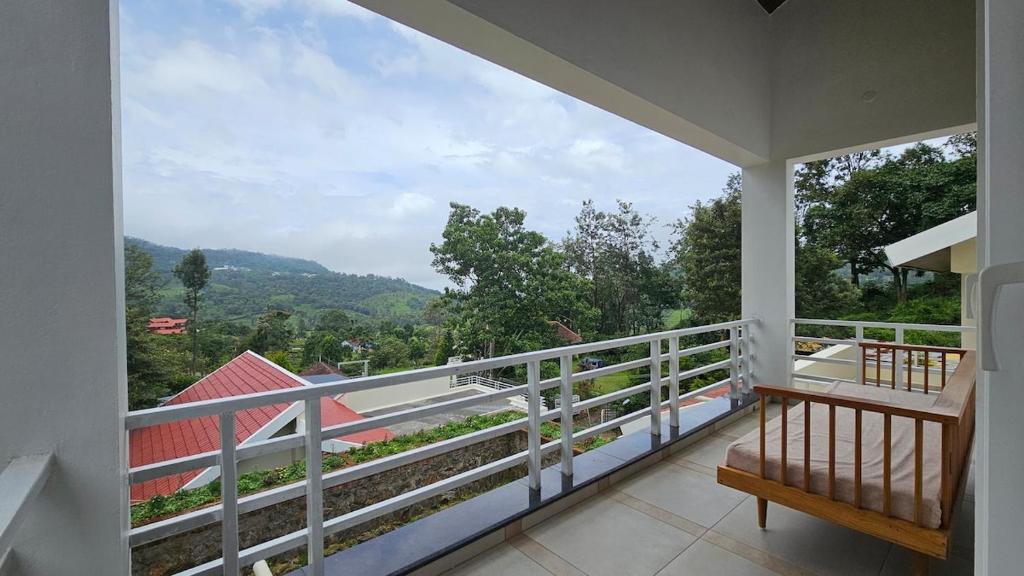 a balcony with a view of the mountains at Mayfield Valley Homestay in Kotagiri