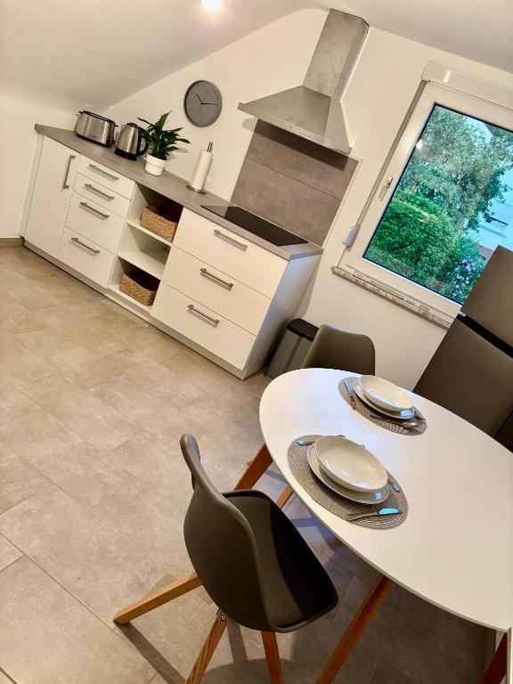 a dining room with a white table and chairs at FeWo Büdingen - Atelier in Büdingen