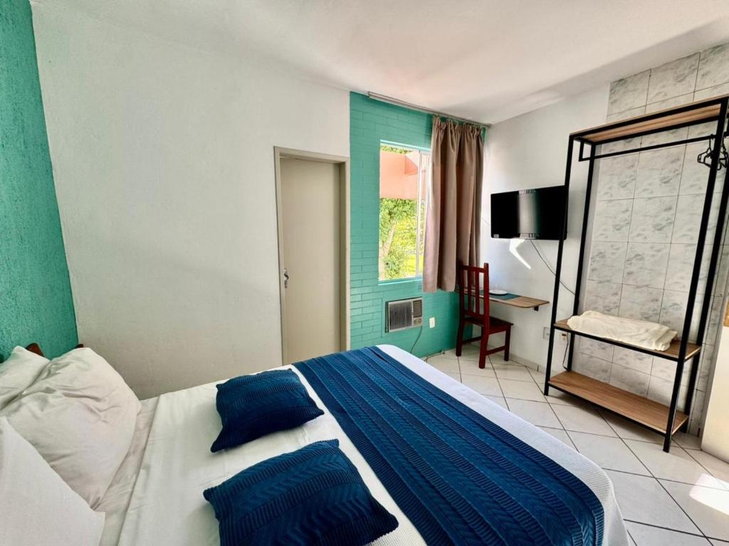 a bedroom with a bed with blue and white at Big Hotel Florianópolis in Florianópolis