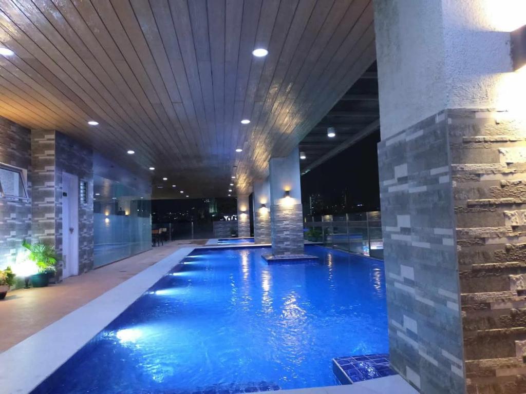 a large swimming pool in a hotel lobby at Cebu Stay Rental - Sunvida Tower Residences in Sampong