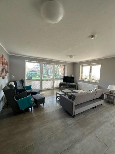 a living room with two couches and a tv at Nike -barrierearm- in Burg auf Fehmarn