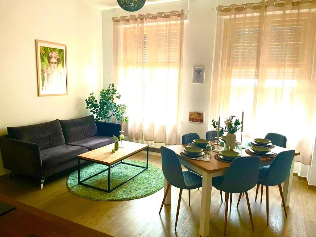 a living room with a table and a couch at NEU- APPARTMENT in HAGEN nähe DORTMUND - 3 Parking! 3 Double-Bed! 2 Bedrooms, WIFI, COFFEMASHINE-Fully Automatic, KITCHEN, NETFLIX,DISNEY,MAGENTA in Hagen