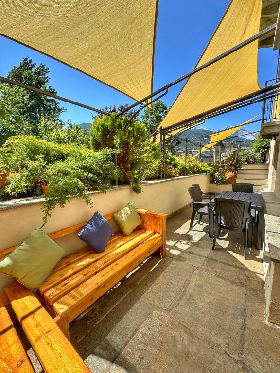 a wooden bench sitting on top of a patio at ' La Tavernetta ' del Principe in Oulx