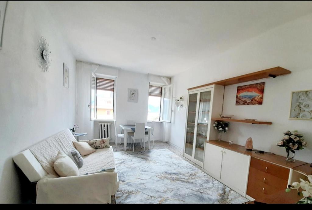 a living room with a couch and a table at Luino Flowers Home in Luino