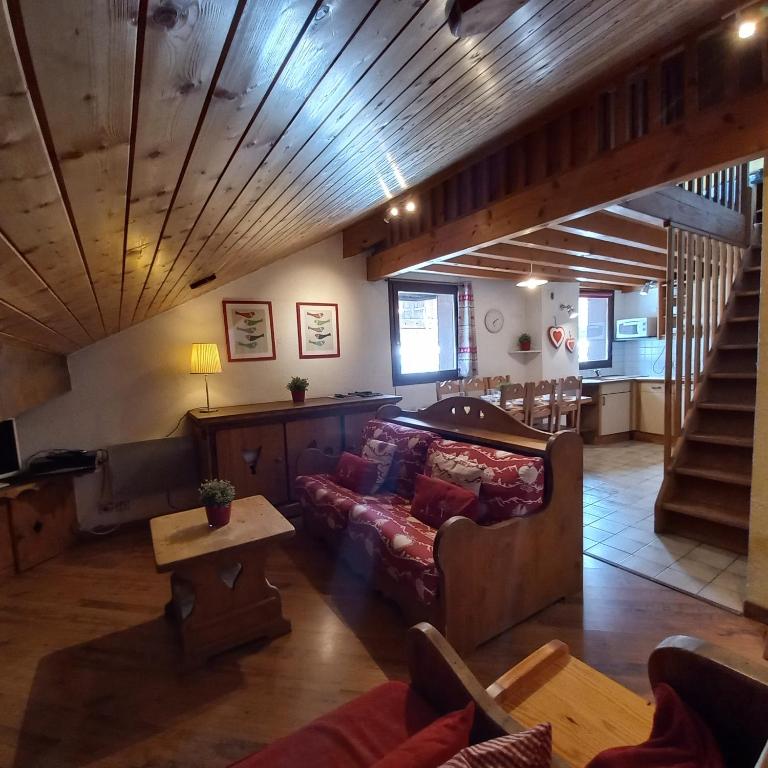 Hotel Lou Veno, a living room with a couch and a staircase at Lou Veno in Les Deux Alpes