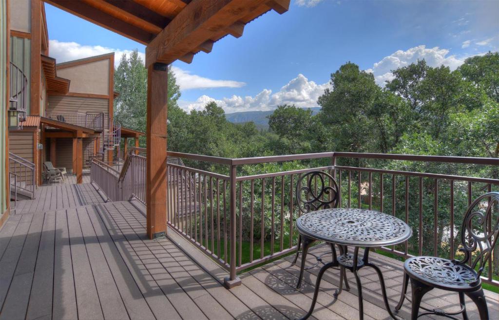 a patio with a table and chairs on a balcony at Tamarron Gambel Oak - 778 in Durango