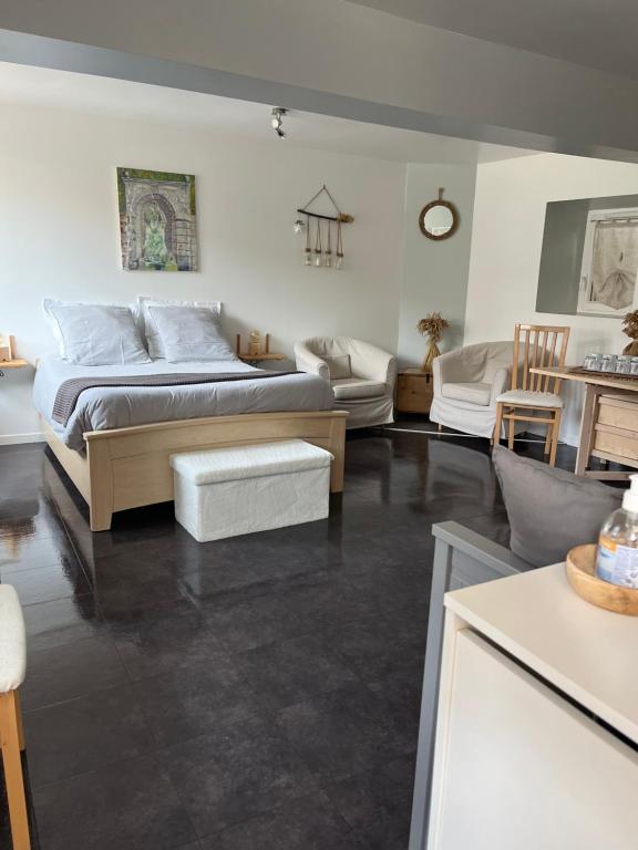 a bedroom with a bed and a living room at Les Jardins d'Eva et Gotham in Civières