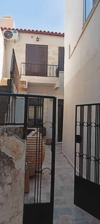 an open door to a building with a balcony at Archanes grandma's house in Archanes