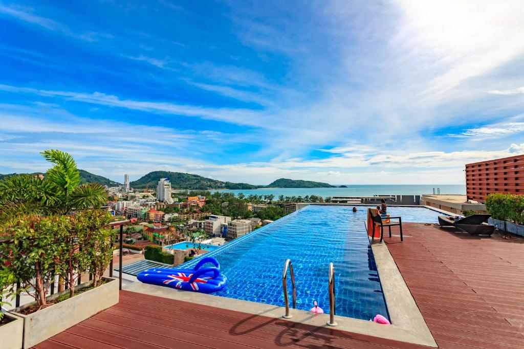 a swimming pool on the roof of a building at Apartments at The Bliss Condo by Lofty in Patong Beach