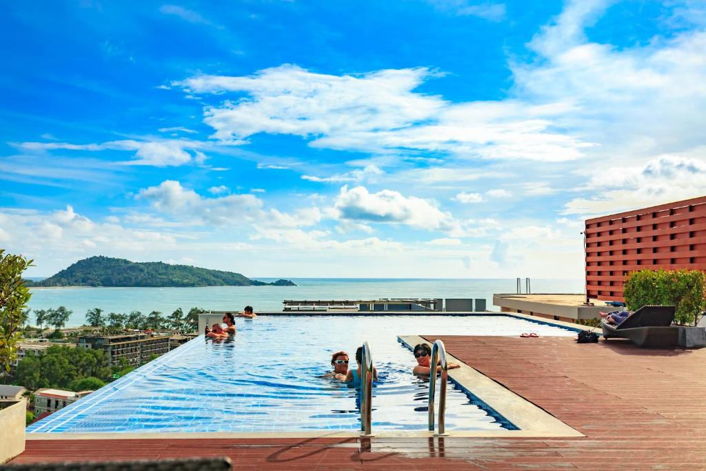 a group of people in a swimming pool at a resort at Apartments at The Bliss Condo by Lofty in Patong Beach