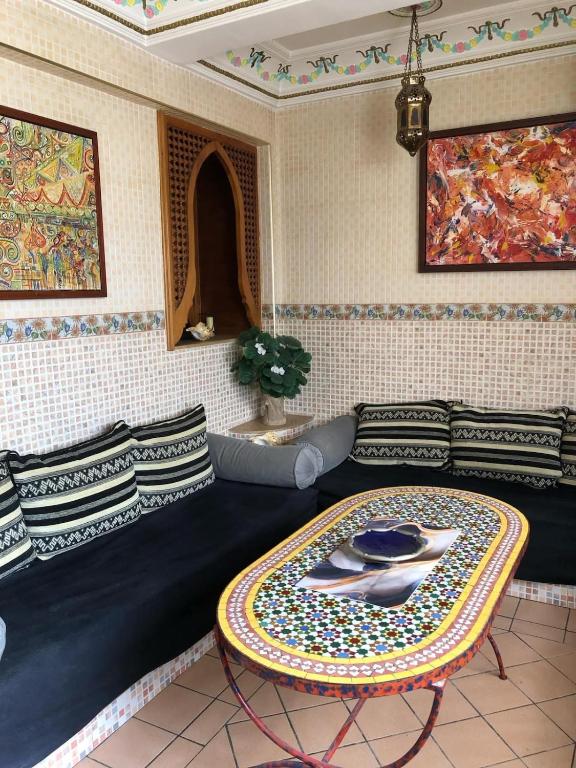a living room with a couch and a table at Appartement typique Marocain in Agadir