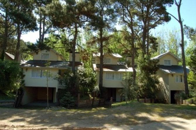 a large house with trees in front of it at Mar Azul casa con servicios Colibri in Mar Azul
