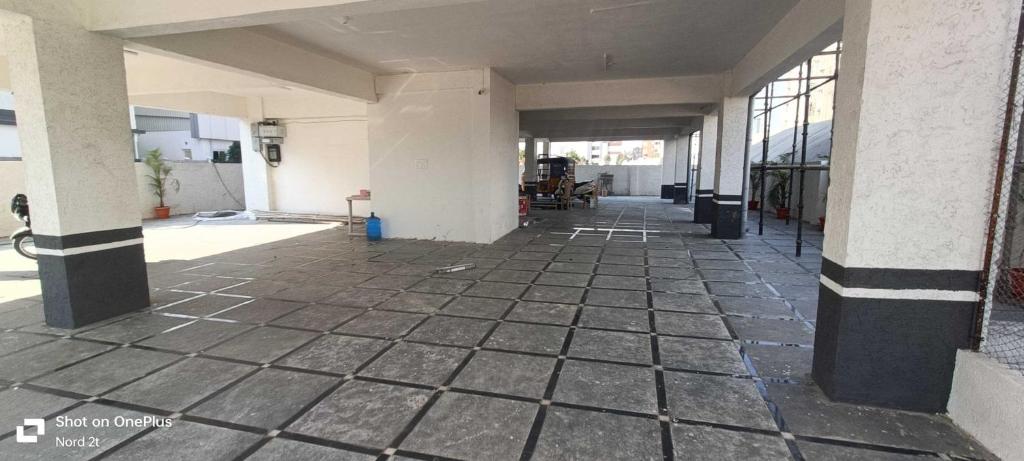 an empty hallway of a building with black and white columns at Townhouse Cineplanet Kompally in Hyderabad