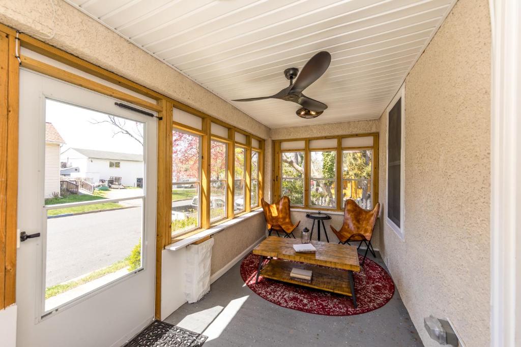 a porch with a table and chairs and a ceiling fan at Charming Havre de Grace Home Walk to Downtown in Havre de Grace