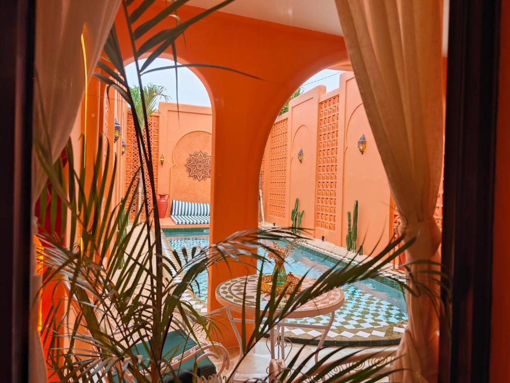 a view of a pool from a room with windows at Güzel Villa Bali in Badung