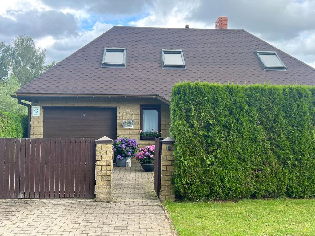 a house with a fence and a garage at Guests house "Like Home" rooms in Sigulda
