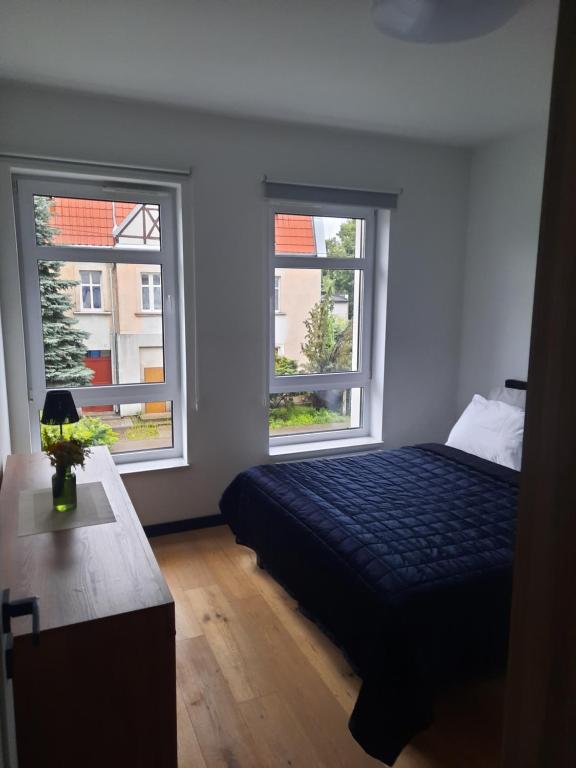 Postel nebo postele na pokoji v ubytování APARTAMENT KOŚCIUSZKi 54