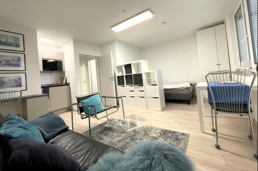 a living room with a couch and a bedroom at Appartment Schwabenblick in Augsburg