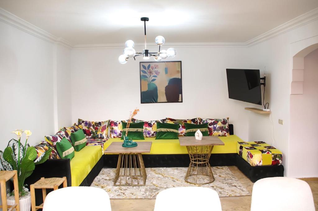 a living room with a couch and a table at Gueliz Appartement in Marrakech