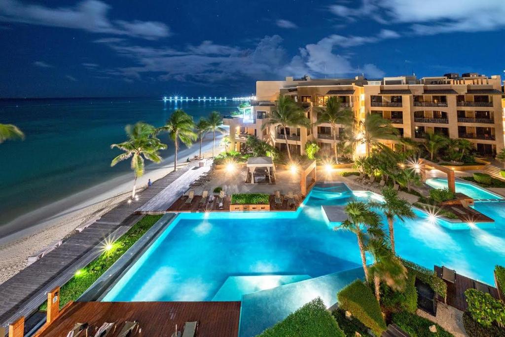 an aerial view of the hotel and the beach at night at Beach Front - Ocean View 1 BR Condo w Terrace & Hughe Infinity Pool Heart of Playa del Carmen in Playa del Carmen