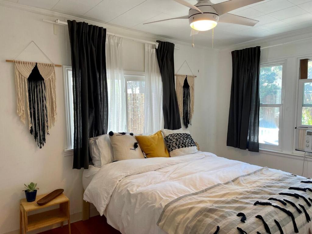 een slaapkamer met een groot bed en zwarte gordijnen bij Cozy Beach Bungalow- Happynest in Long Beach