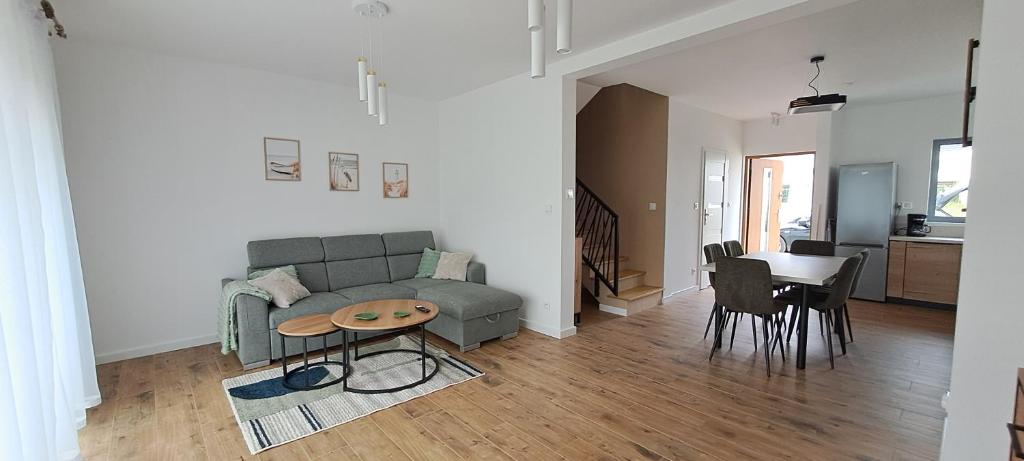 a living room with a couch and a table at Garden Baltic II in Trzęsacz