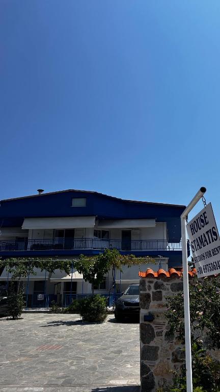 a house with a sign in front of a parking lot at House Stamatis in Sarti