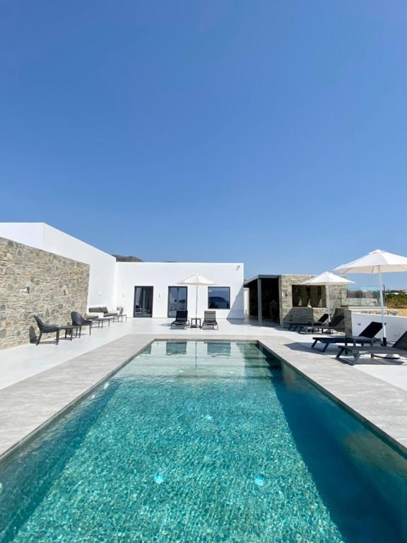 a swimming pool in front of a villa at GBR 2 - Golden Beach Residences in Chrissi Akti