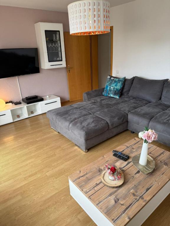 a living room with a couch and a coffee table at Selina's Apartment in Oberthal