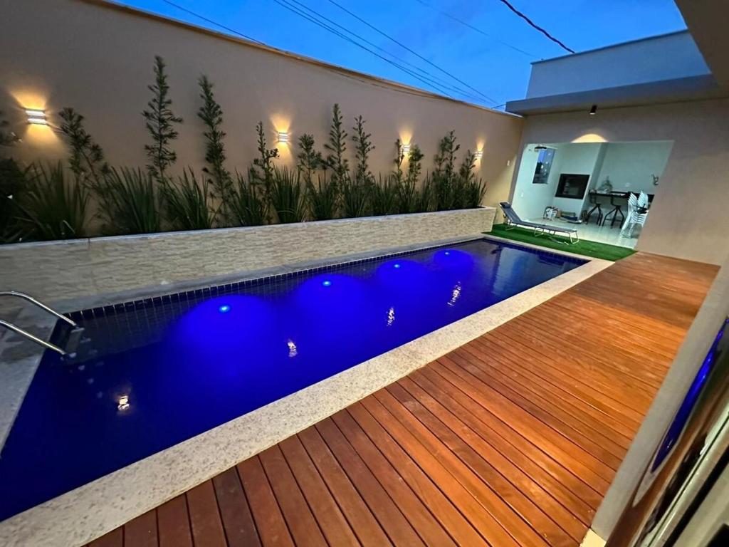 una piscina en una casa con terraza de madera en Recanto Rafiza, en São José de Ribamar