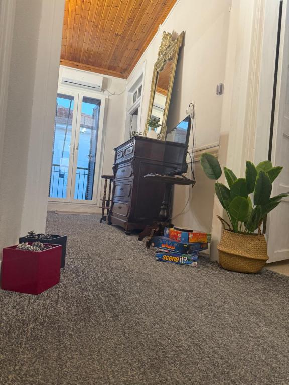 a living room with a piano and a mirror at Elia in Kalamoti
